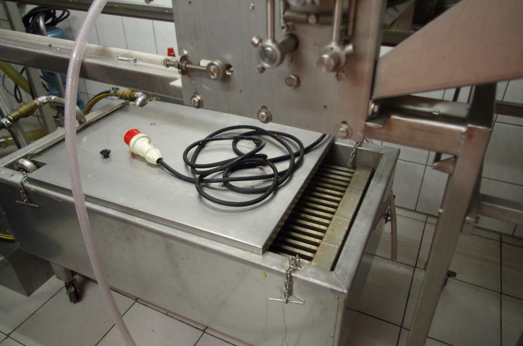 Entdeckeln im grossen Stil gibt viel Entdeckelungswachs - im Direktschmelzer tropft Honig durch aber das Wachs wird auf dem Gitter geschmolzen und schwimmt anschließend auf dem Honig auf.